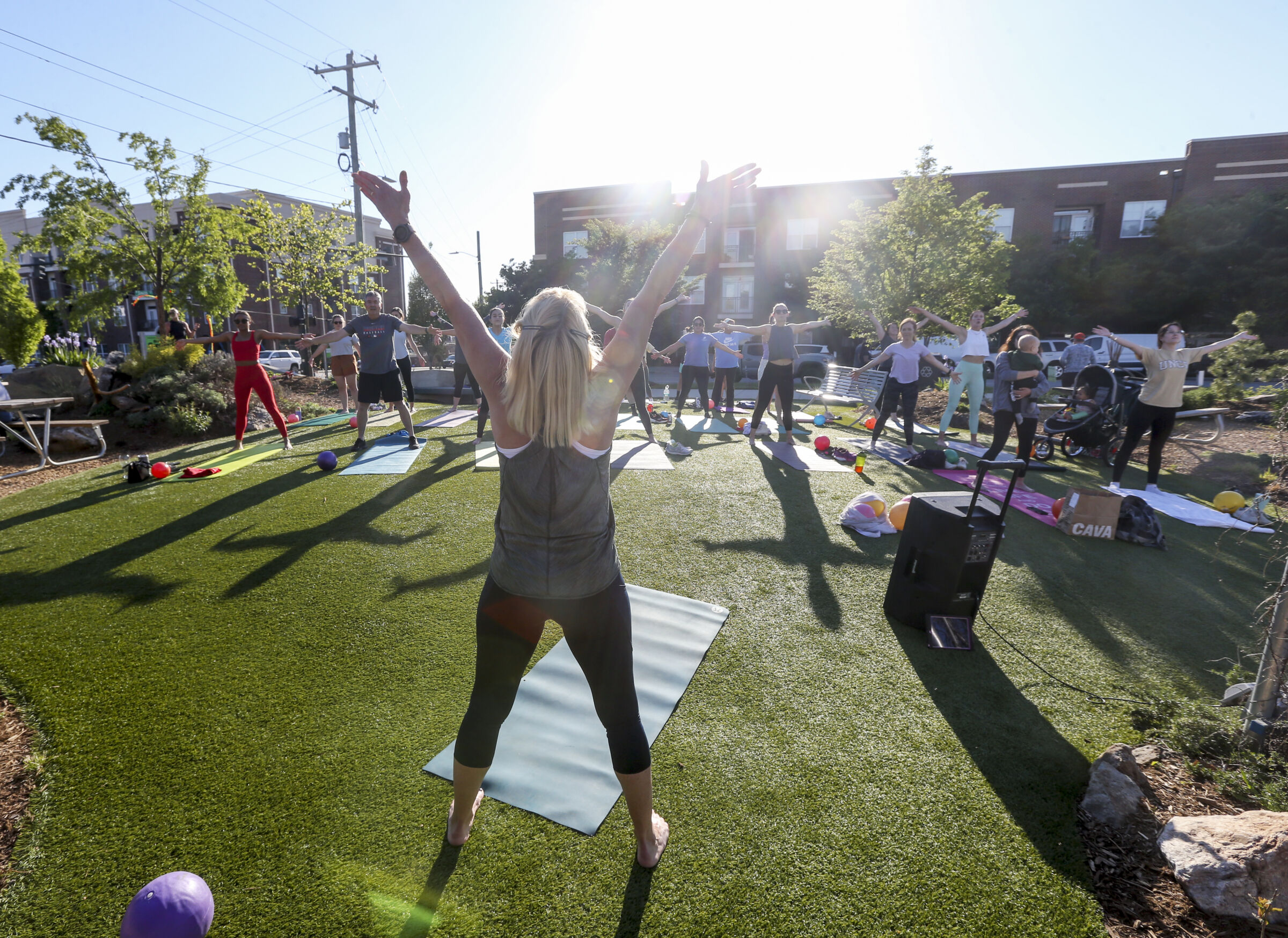 Outdoor yoga class in LoFi Park along Downtown Greenway