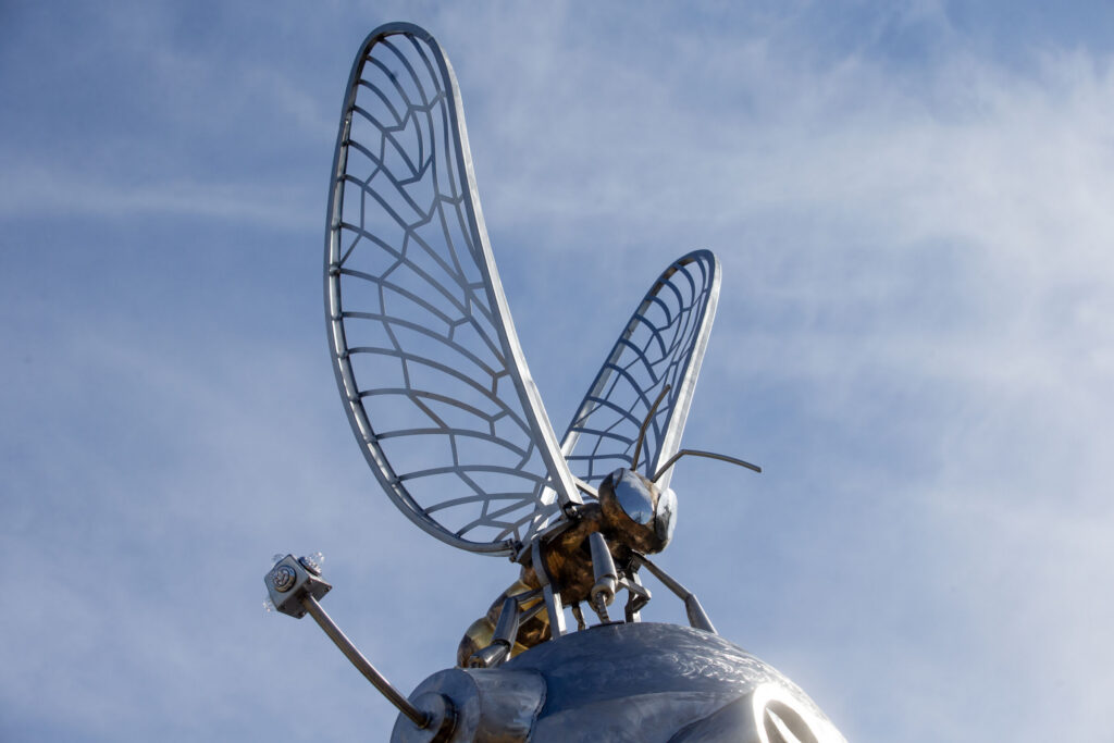 Close-up of metal insect sculpture perched atop a Downtown Greenway public art piece
